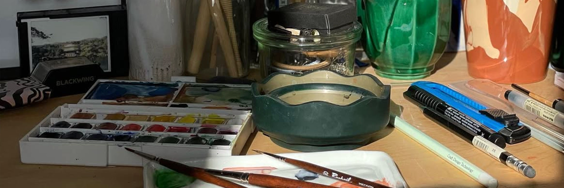 Color palette and brushes on a workshop desk