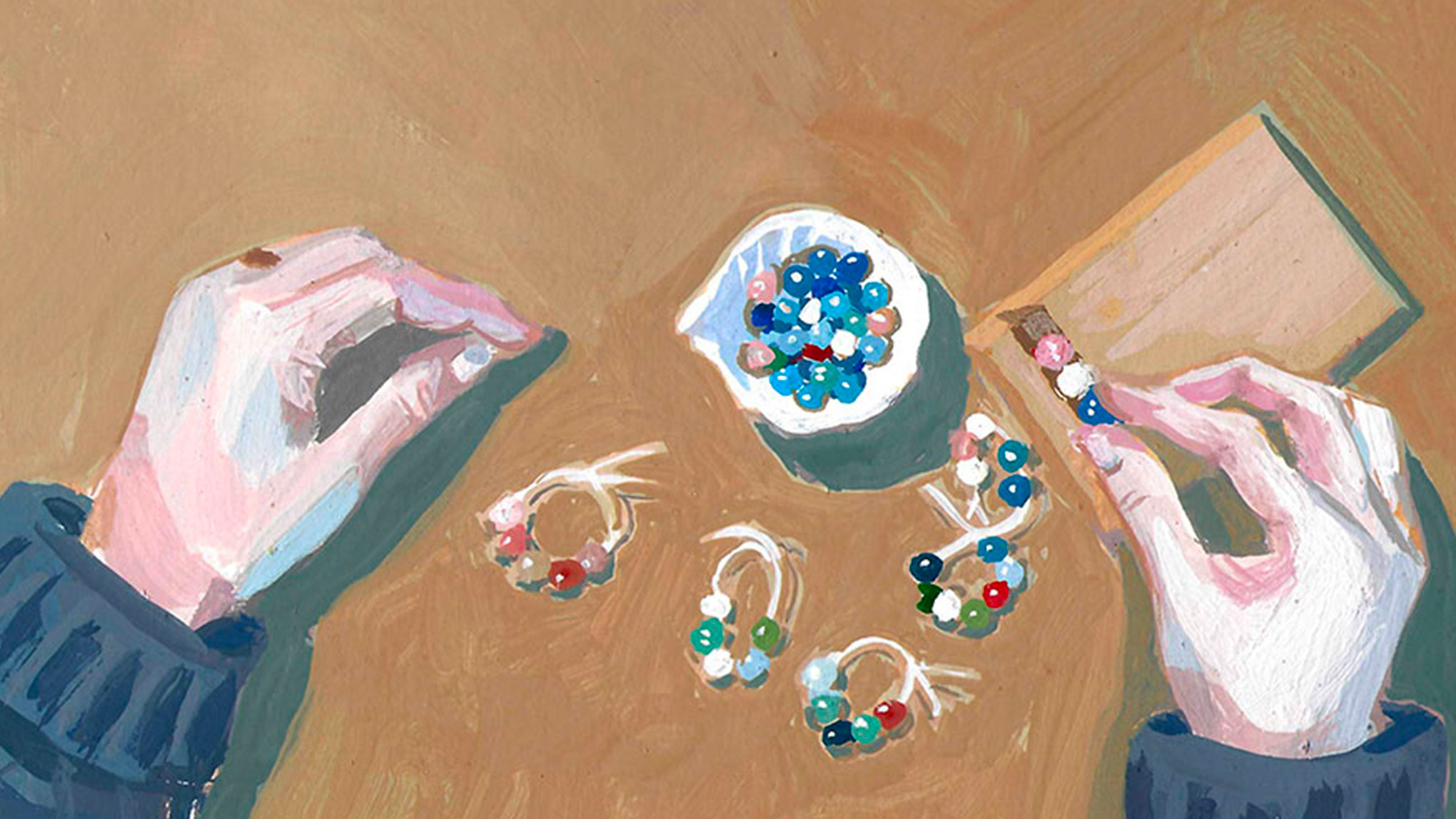 Illustration de mains assemblant des bijoux de perles colorées, vue du dessus